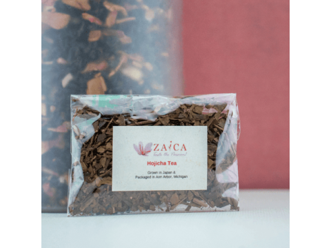 Loose leaf hojicha tea in a small bowl showing toasted brown leaves