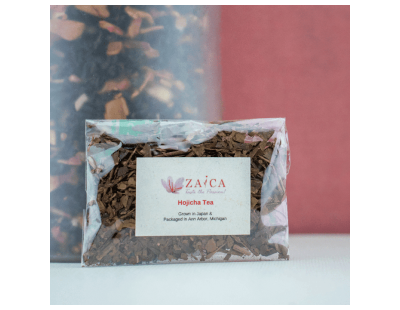 Loose leaf hojicha tea in a small bowl showing toasted brown leaves